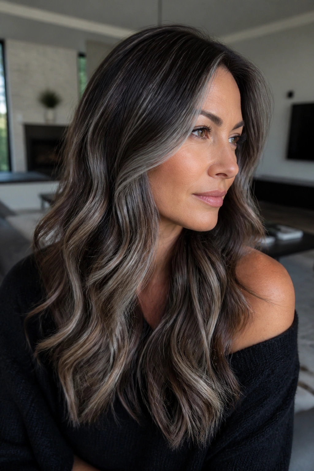Close-up of a real woman with Reverse Grey Balayage smoky grey lowlights on brown hair