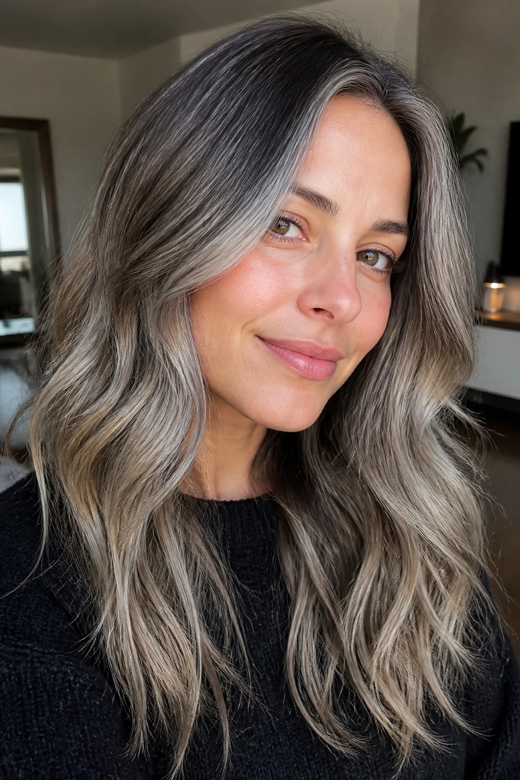 Close-up of hair with a silver root melt gradient from dark roots to silver mid-lengths