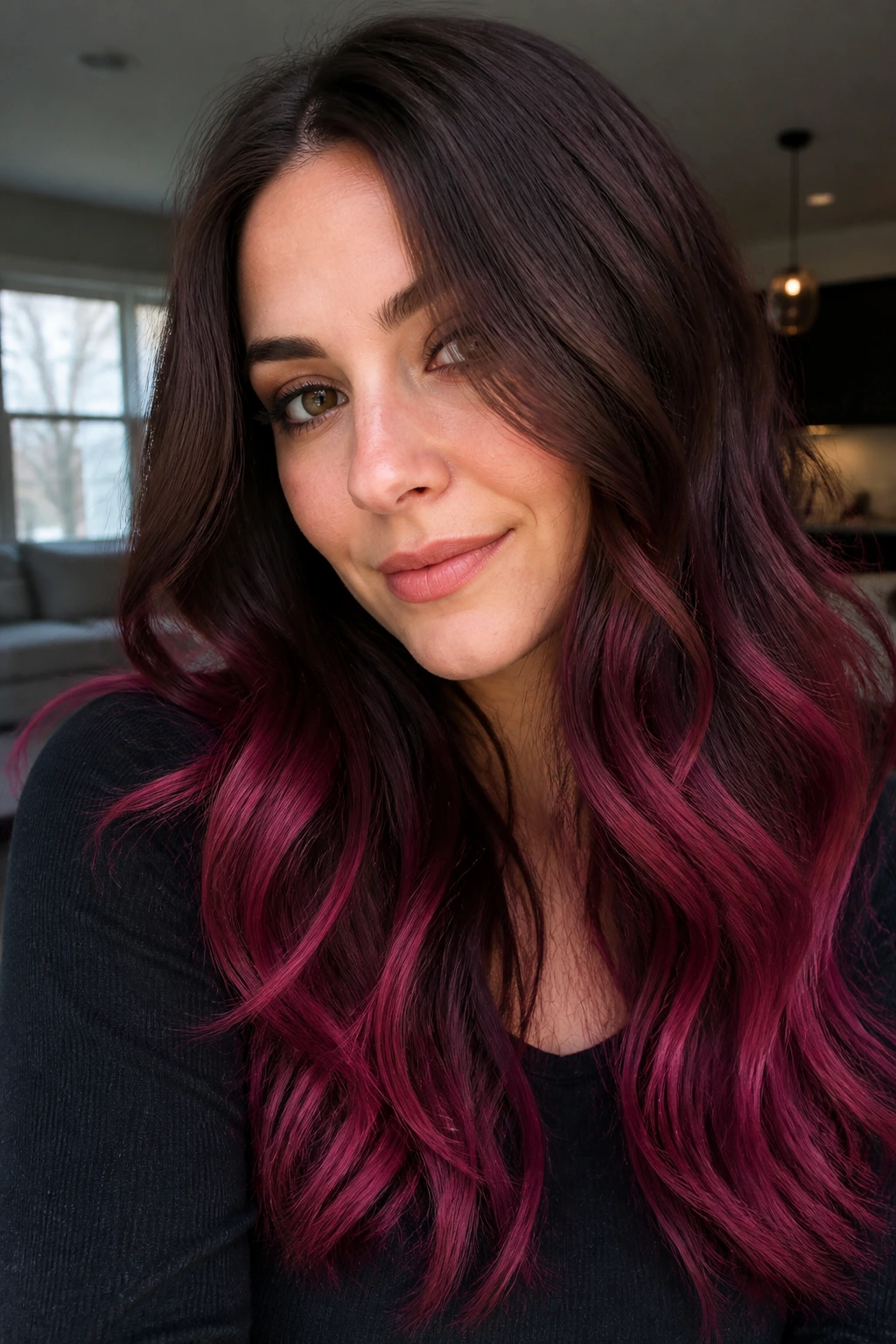 Close-up portrait of long hair transitioning from rooty brunette to raspberry ombre