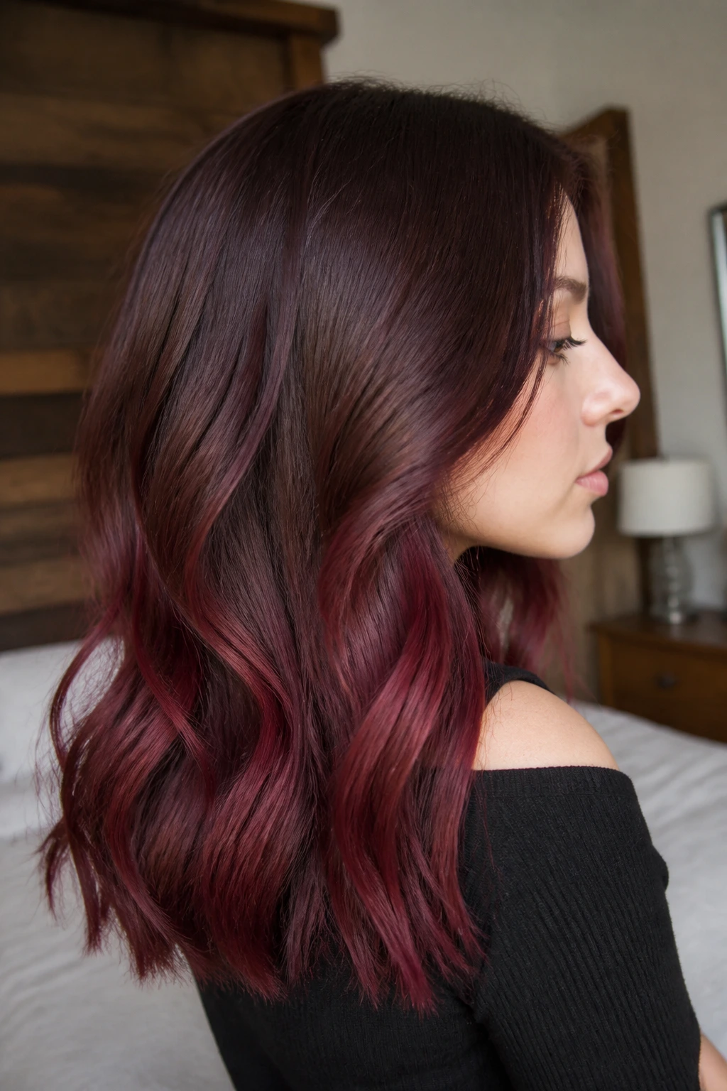 Close-up of a real woman's mid-length burgundy ombre melt in rosewood tones