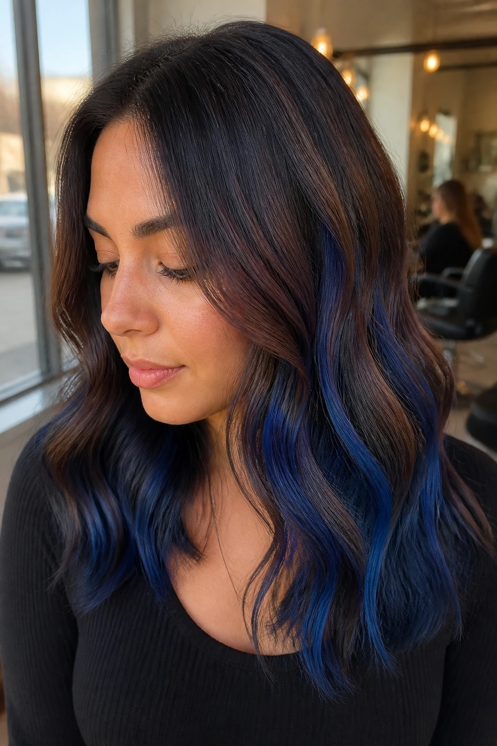 Close-up of warm brunette with royal blue balayage.