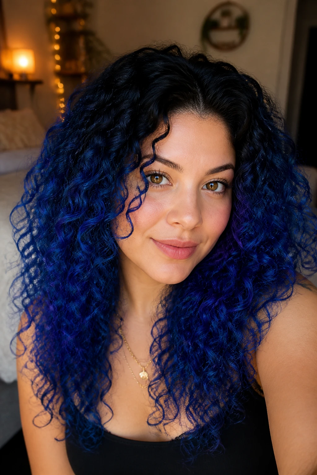 Portrait of royal blue curls with a dark-to-blue root melt