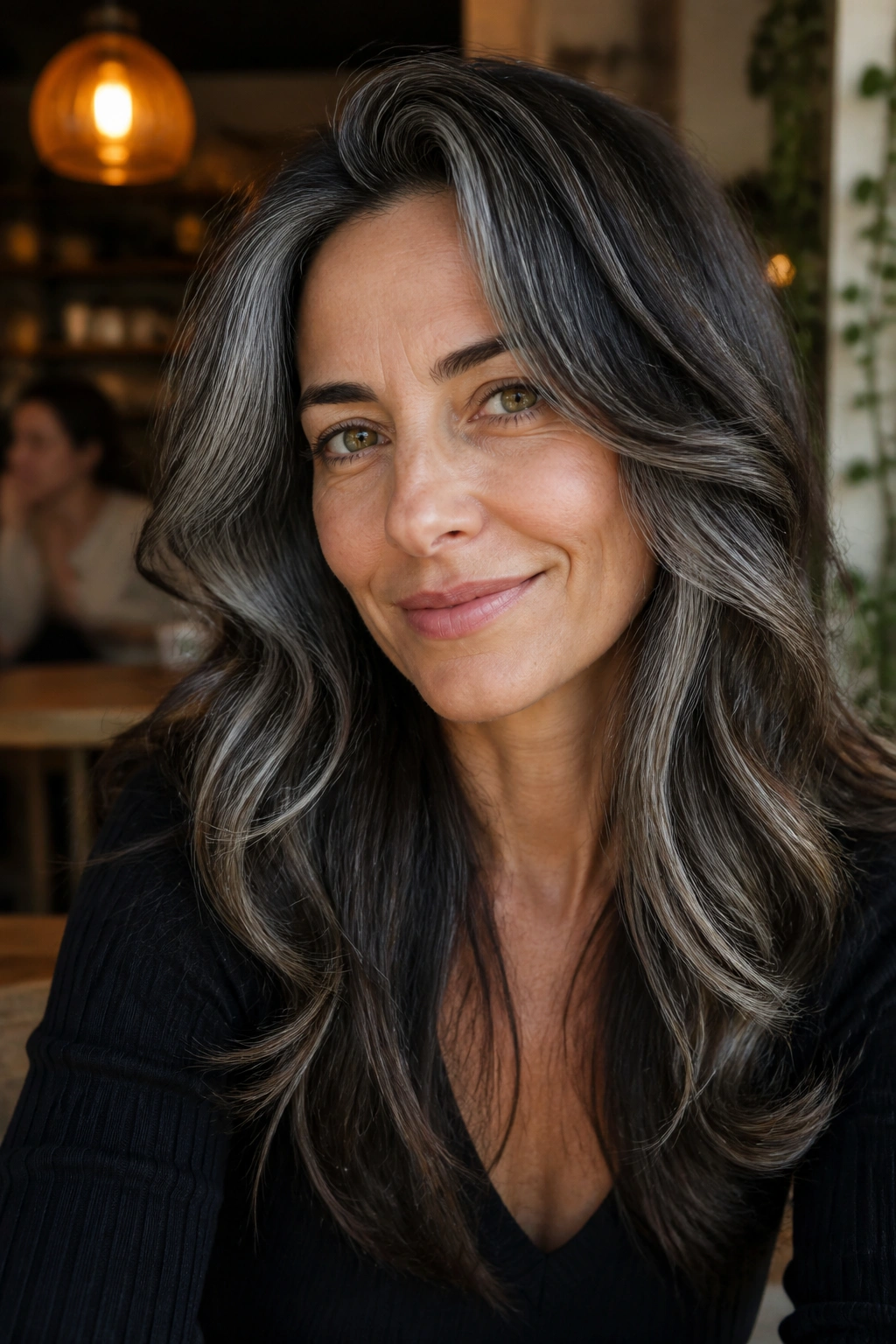 Portrait of a real person with salt-and-pepper balayage on brunette hair.