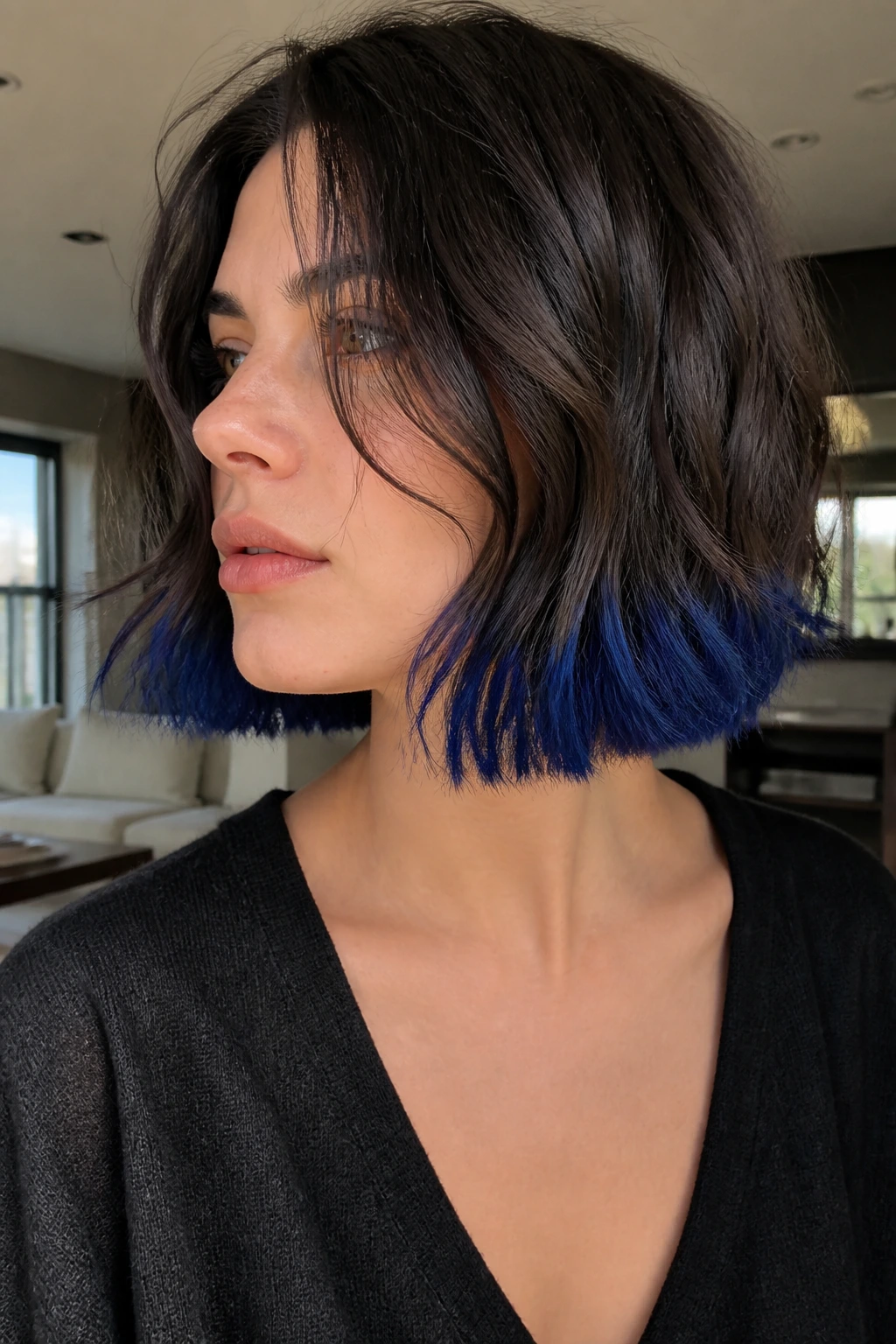 Close-up portrait of a real person showing sapphire blue dip-dye tips at the ends