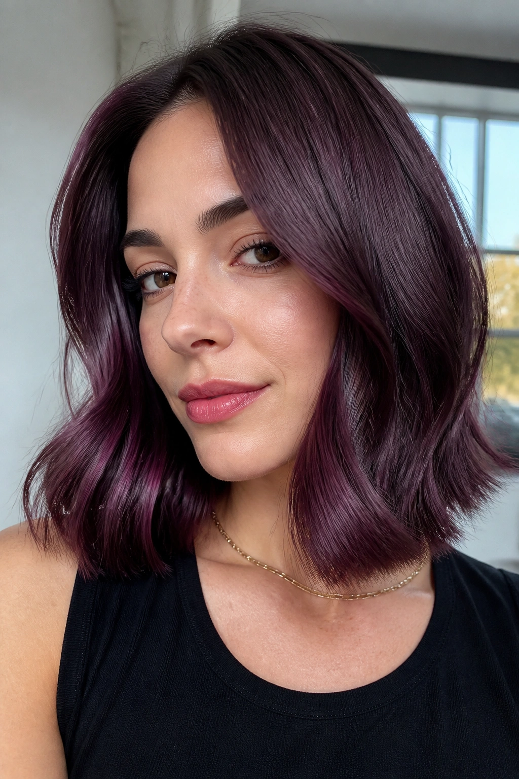 Close-up of real person with satin plum lob in window light
