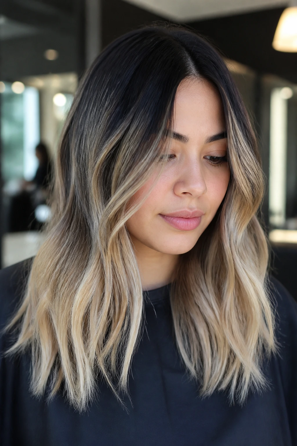 Real person with a smudged black shadow root and bright ends in a salon