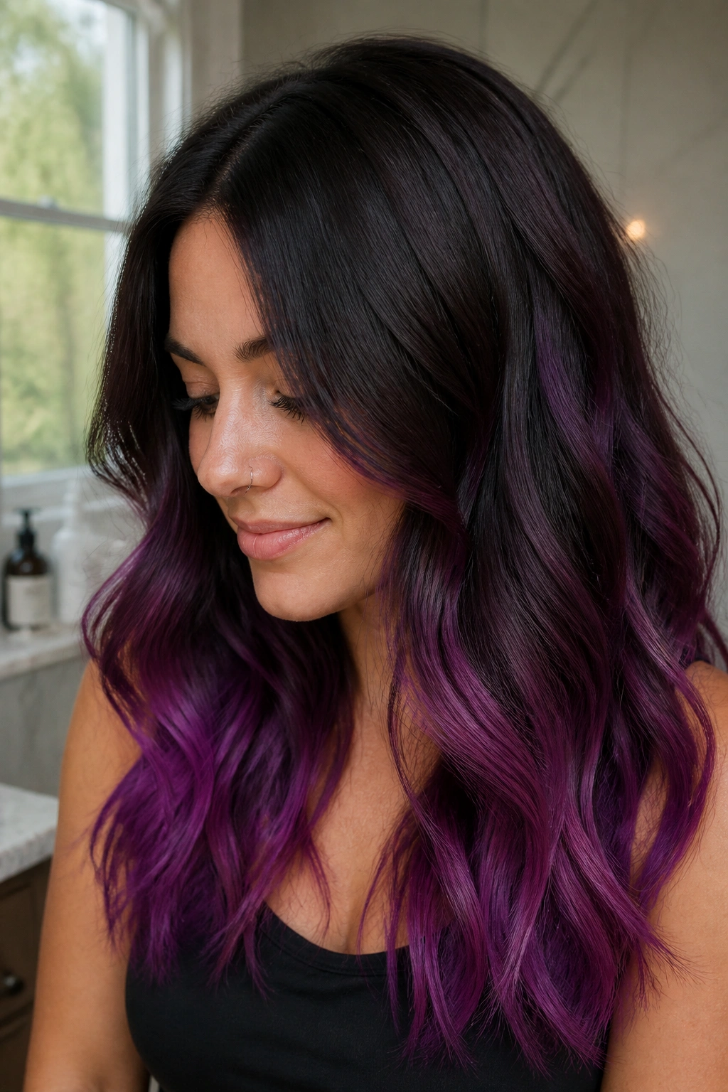 Close-up of dark-rooted hair with bright orchid tips in a bathroom setting