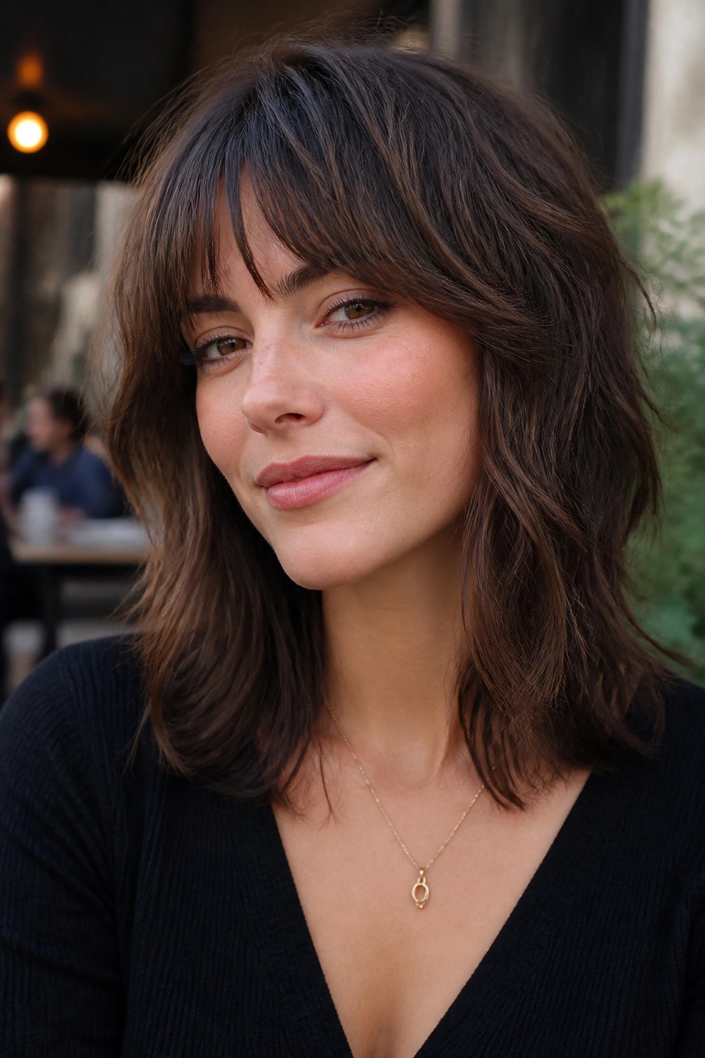 Real woman with shag bangs and messy layers in brunette hair