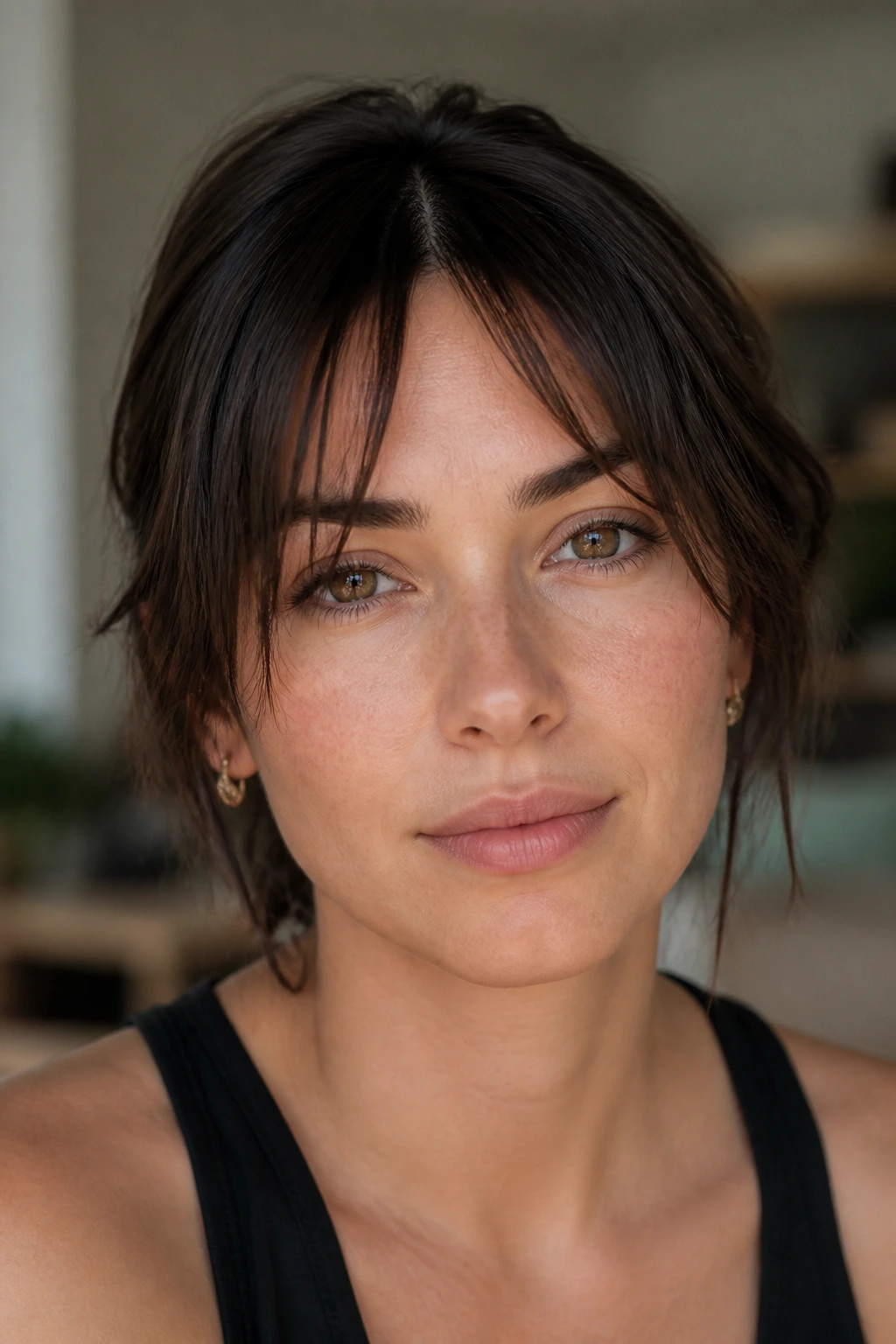 Close-up portrait of a real woman with center-split shattered wispy bangs.