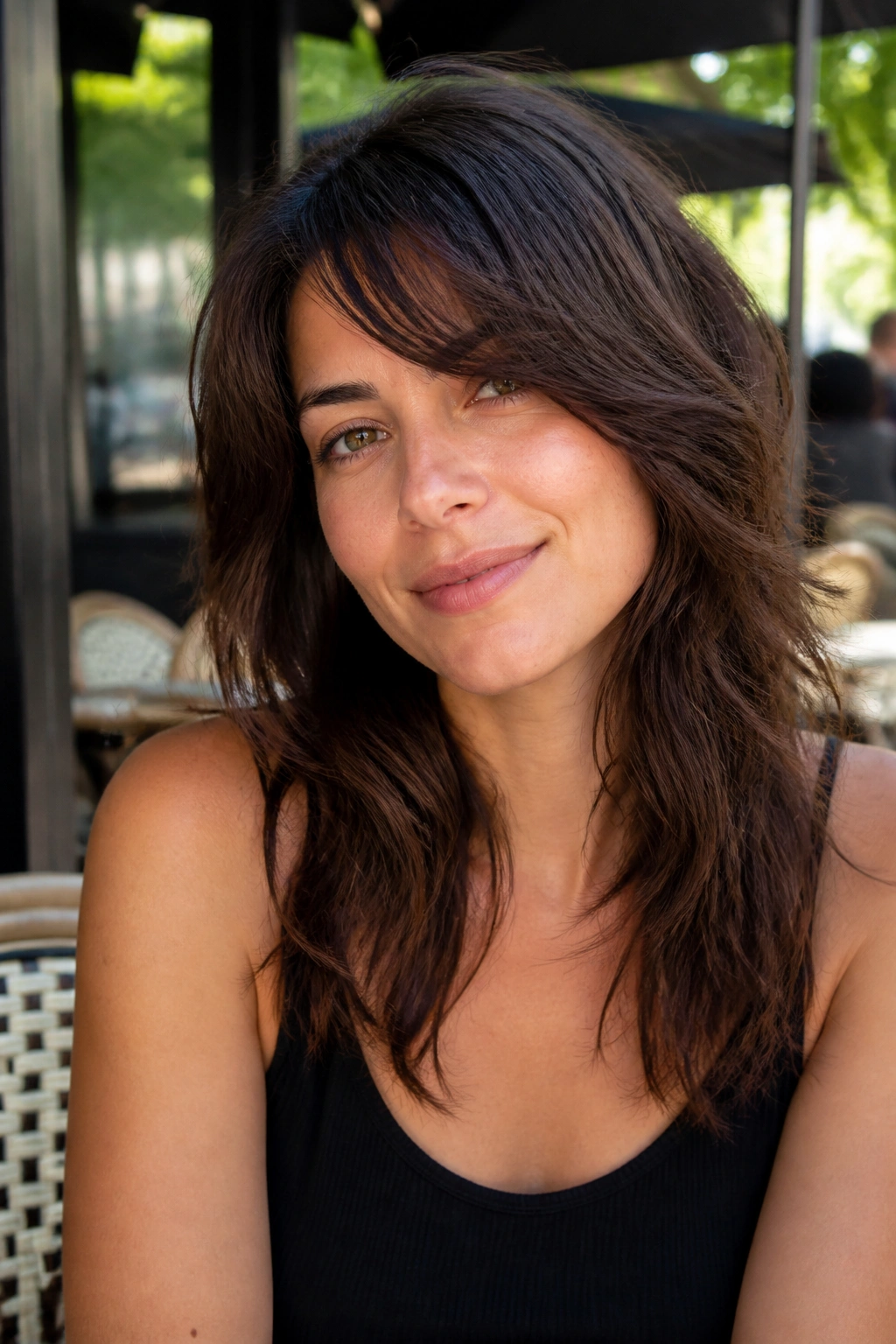 Close-up of woman with side-bang shag cutting across width of face