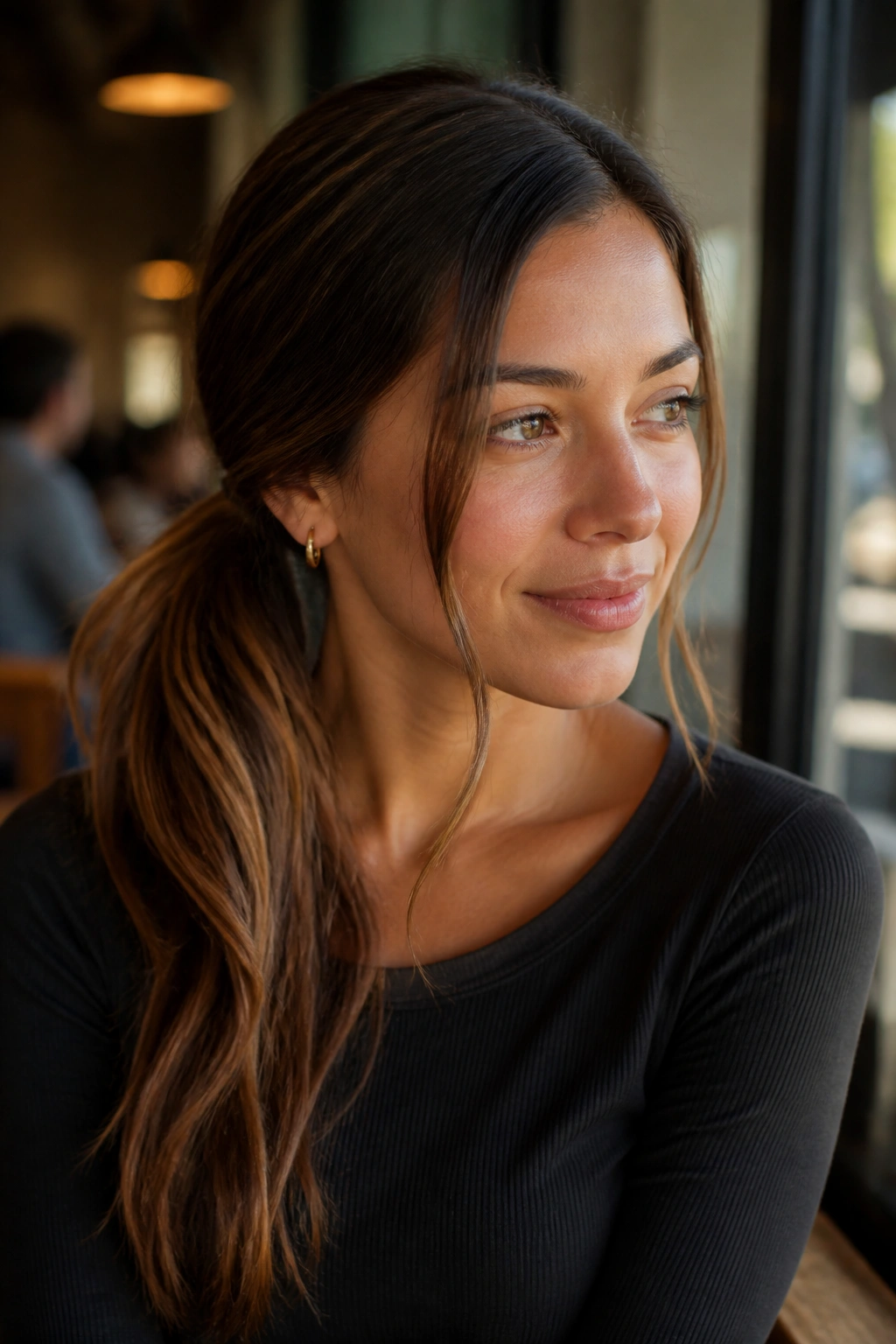 Close-up of a real woman with a side ponytail and face-framing pieces