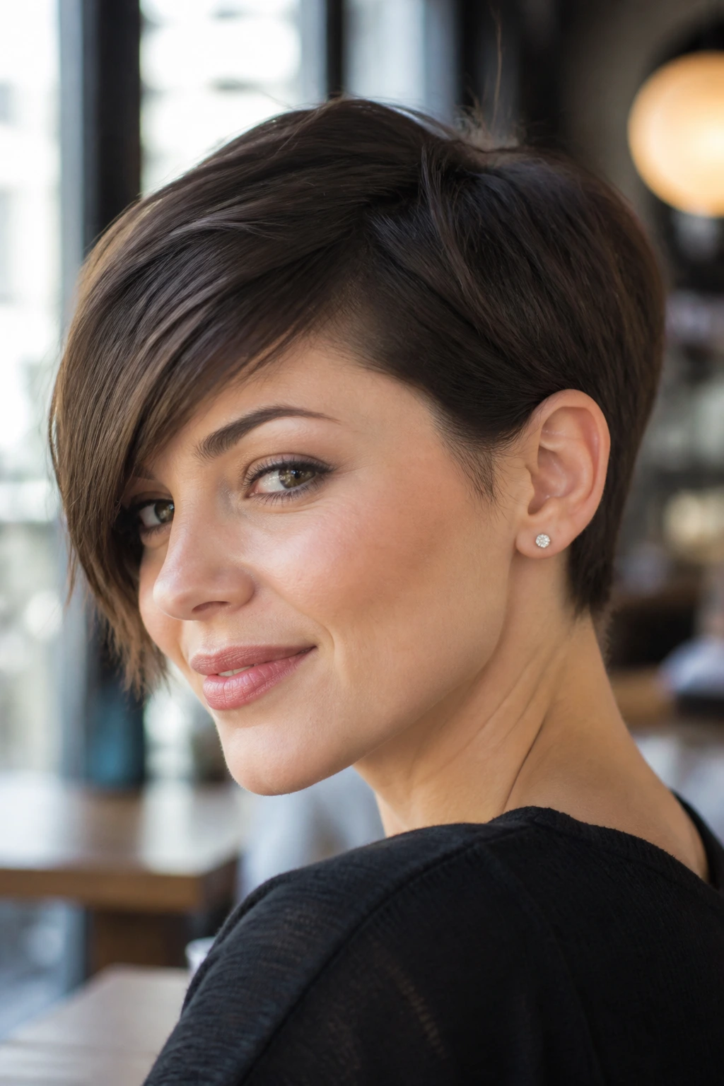 Close-up portrait of a real person with a side-swept pixie and ear tuck