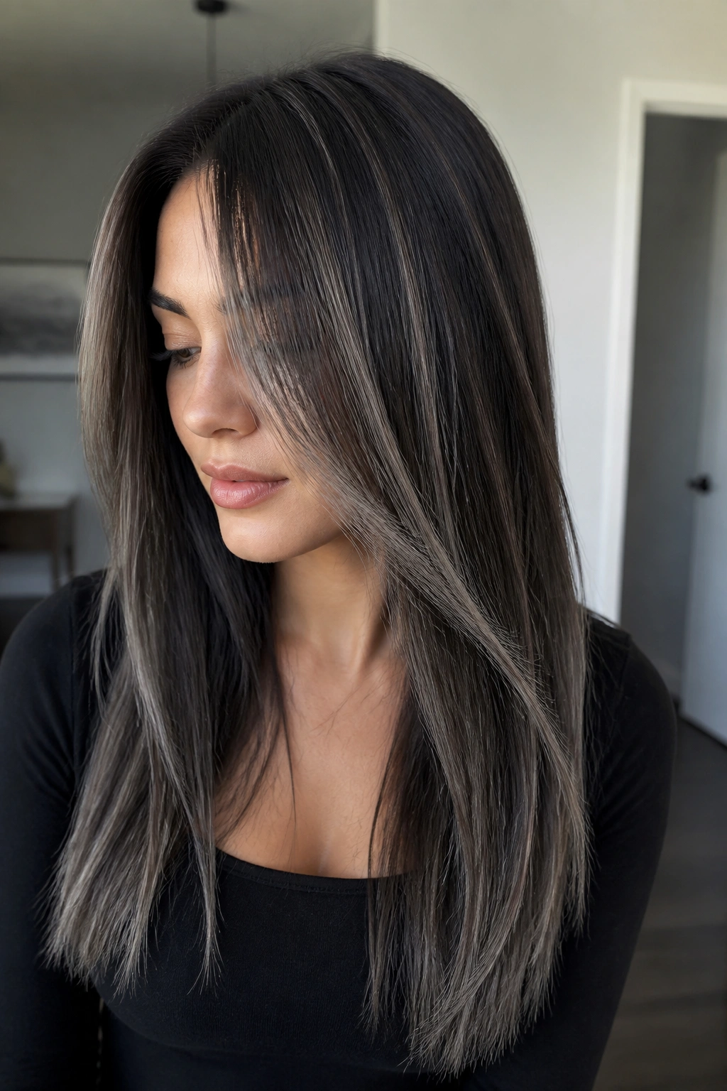Portrait of a woman with espresso brown hair and silver ash highlights.