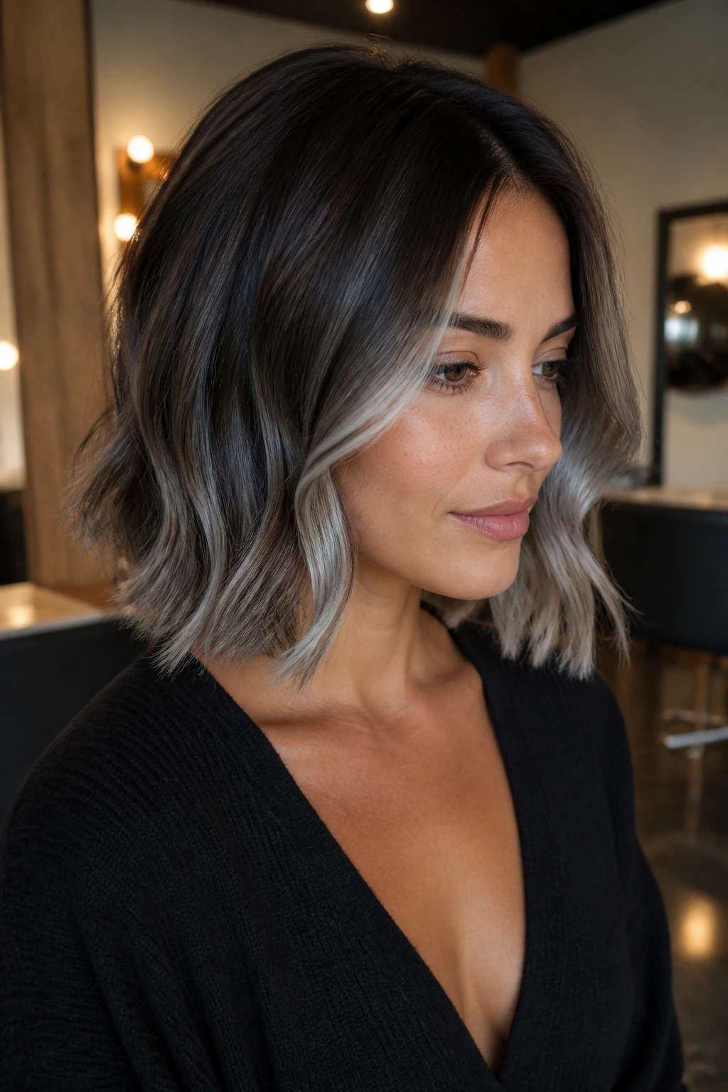 Close-up of a chocolate brown lob with silver balayage highlighting the ends