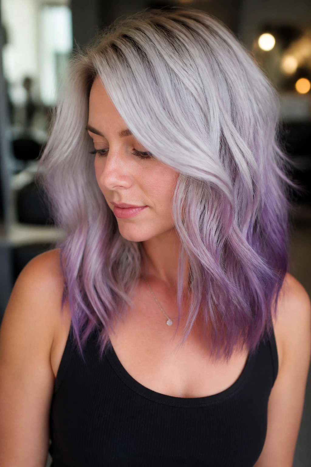 Close-up of a real woman with silver blonde hair and smoky purple balayage
