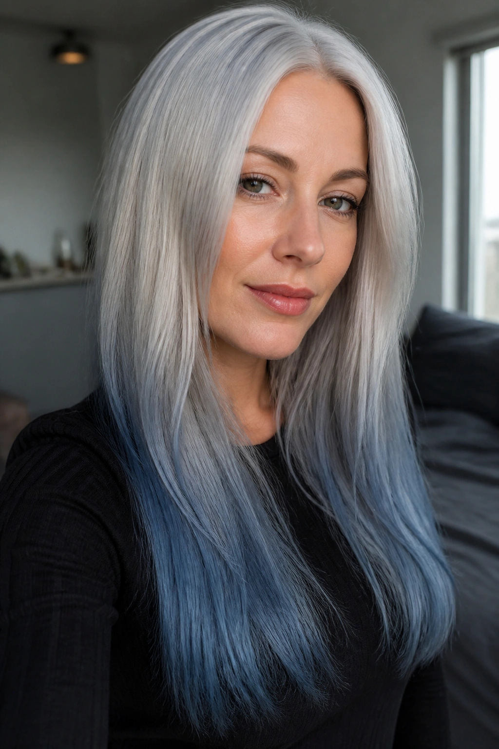 Real person with silver-white roots and muted blue ends in long straight hair