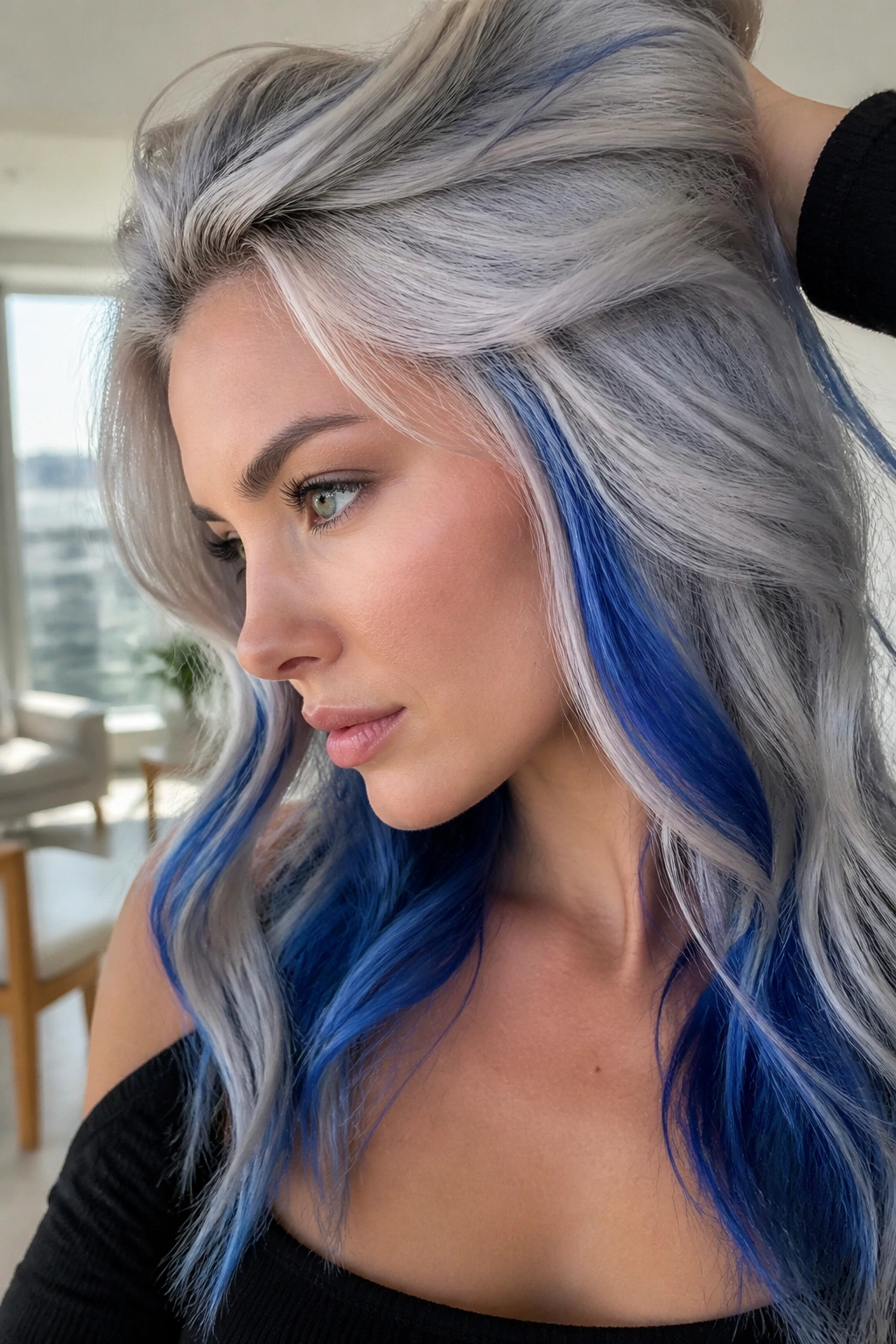 Close-up portrait of a real woman with silver ice blonde hair and cobalt lowlights.