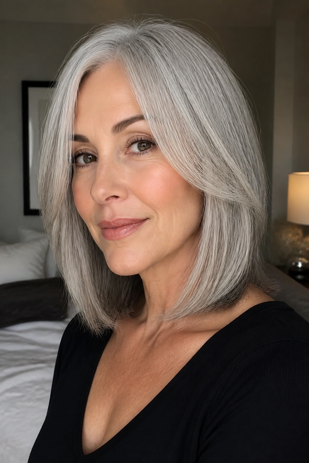 Close-up of a real woman with a silver lob haircut featuring cheekbone-length layers