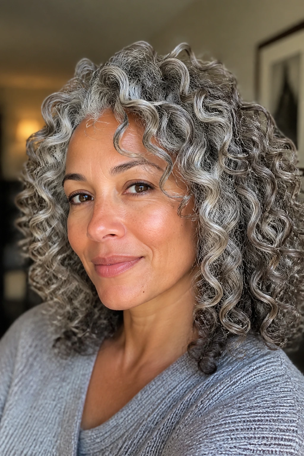Salt-and-pepper curls with silver and pearl highlights.