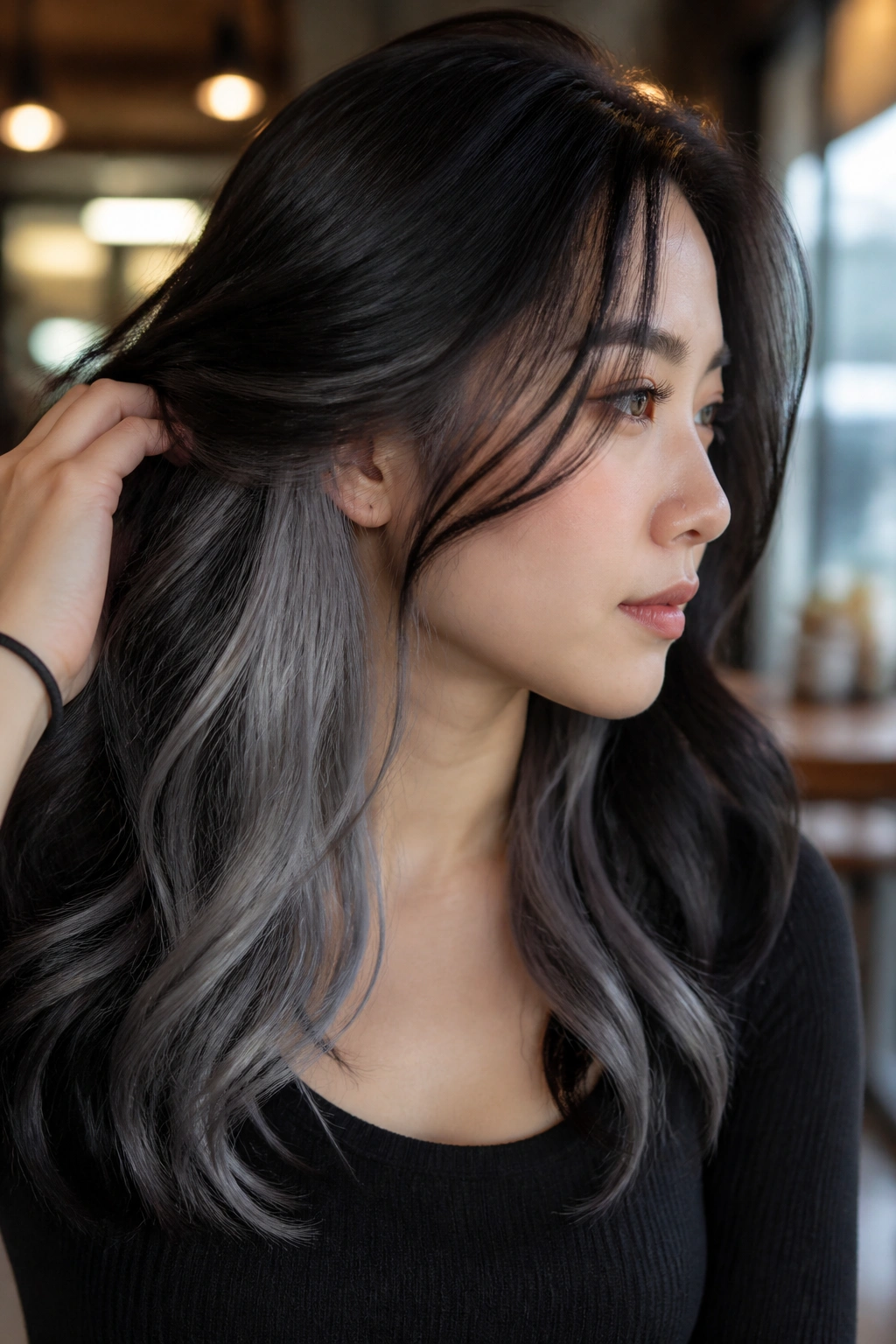 Close-up portrait of a real person with a silver underlayer peeking from dark hair.