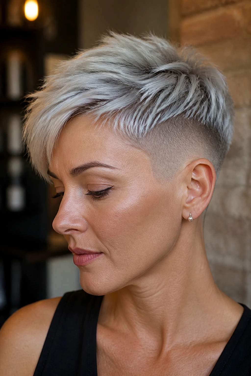 Real woman with silver pixie undercut; side shaved visible, portrait