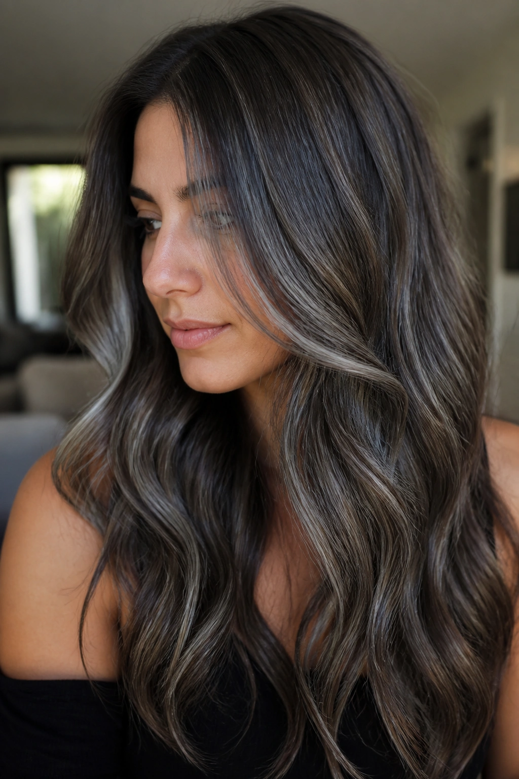 Close-up of a real person with wavy brunette hair featuring a soft silver veil