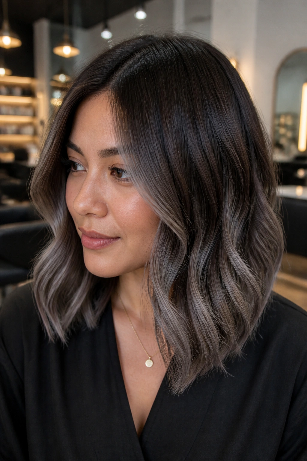 Close-up of dark mocha hair with slate balayage on a lob.