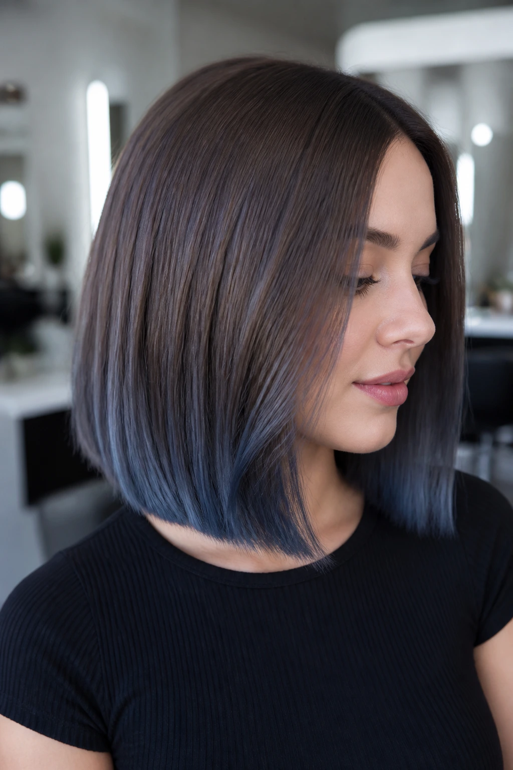 Portrait of a woman with slate brown lob and blue-glazed ends.
