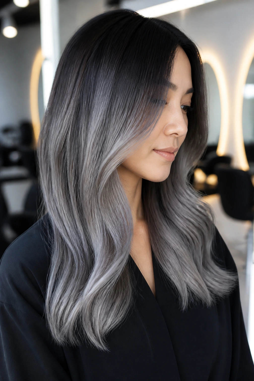 3/4 profile portrait of a woman with slate gray ombre hair.