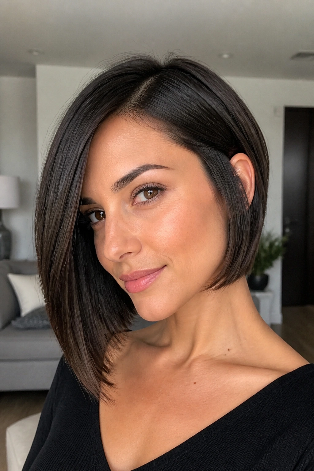 Close-up of a real woman with a sleek asymmetrical bob and hidden layers