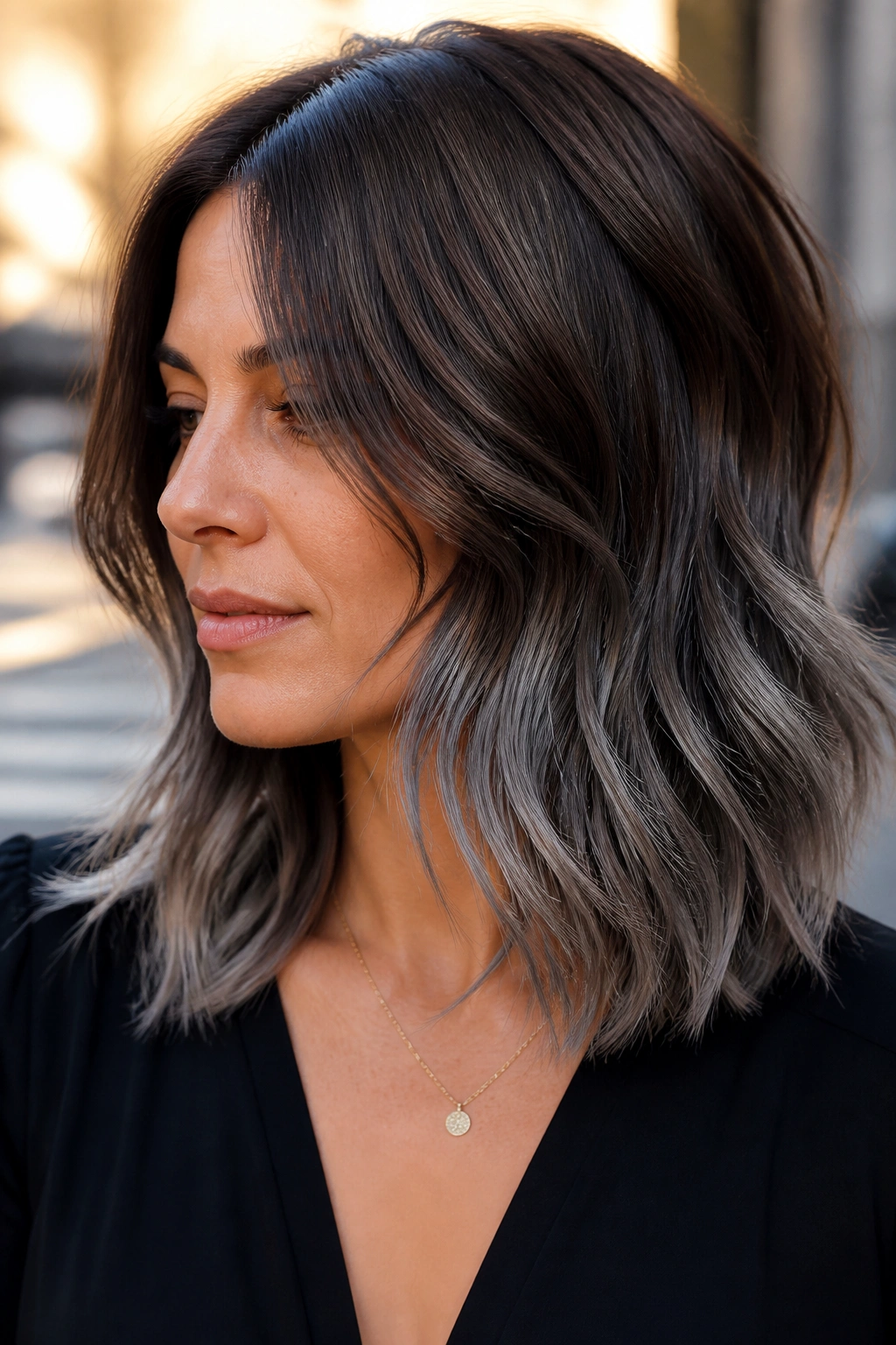 Close-up portrait of woman with smoke-dipped ends on shoulder-length layers