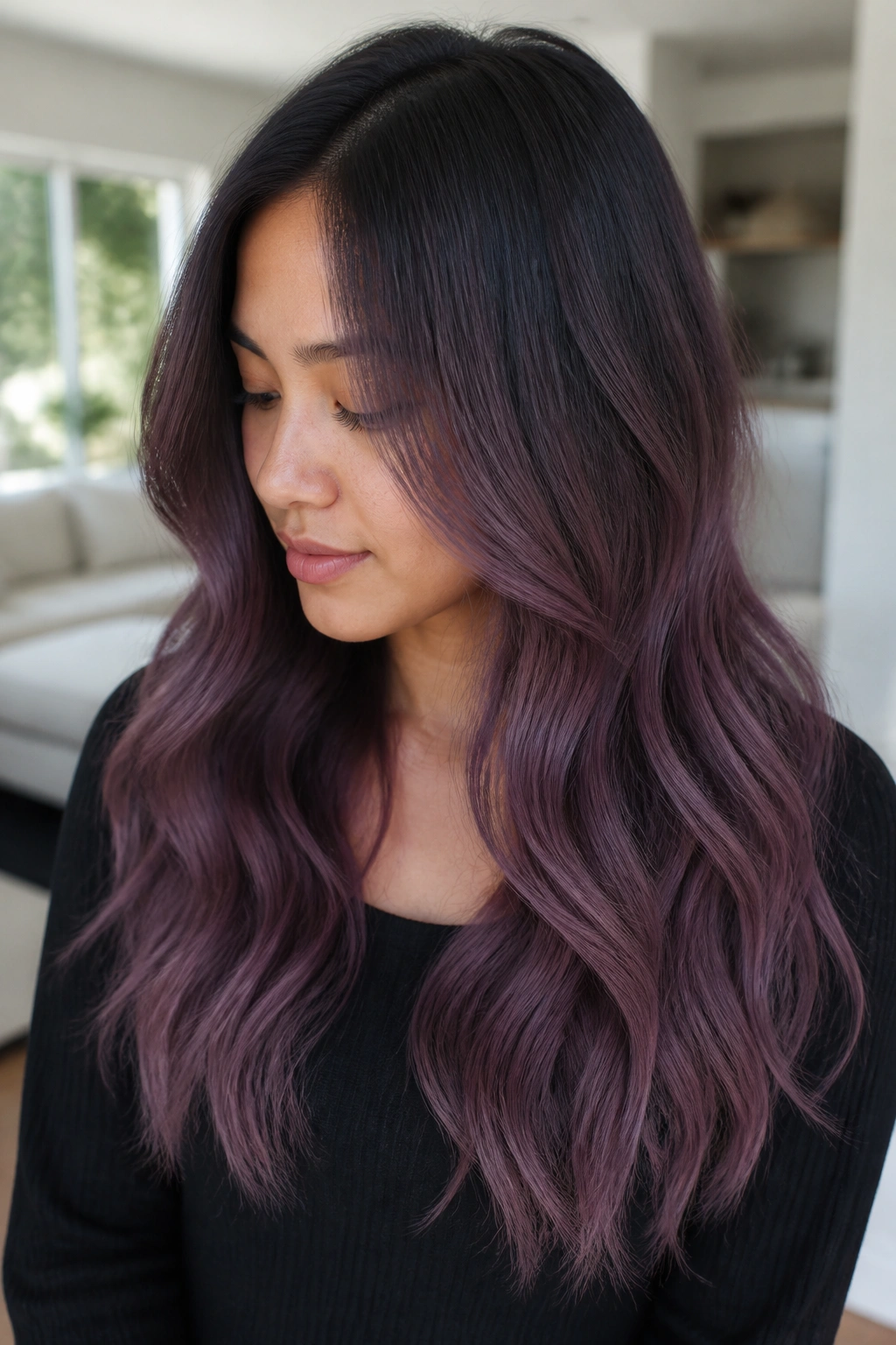 Portrait of a person with smoke plum ombre hair in a bright living room