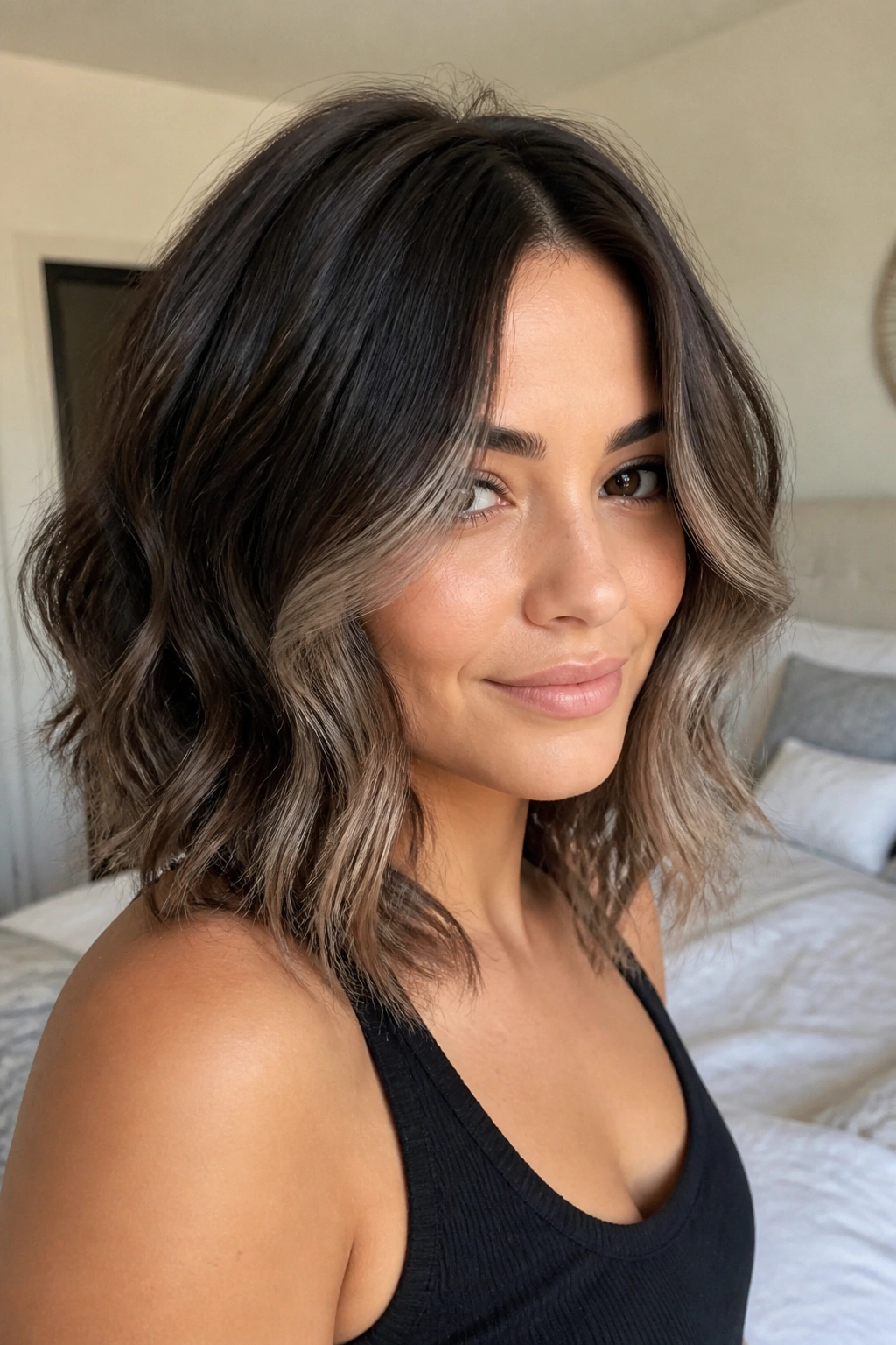 Shoulder-length waves with smoky ash tips framing the face.