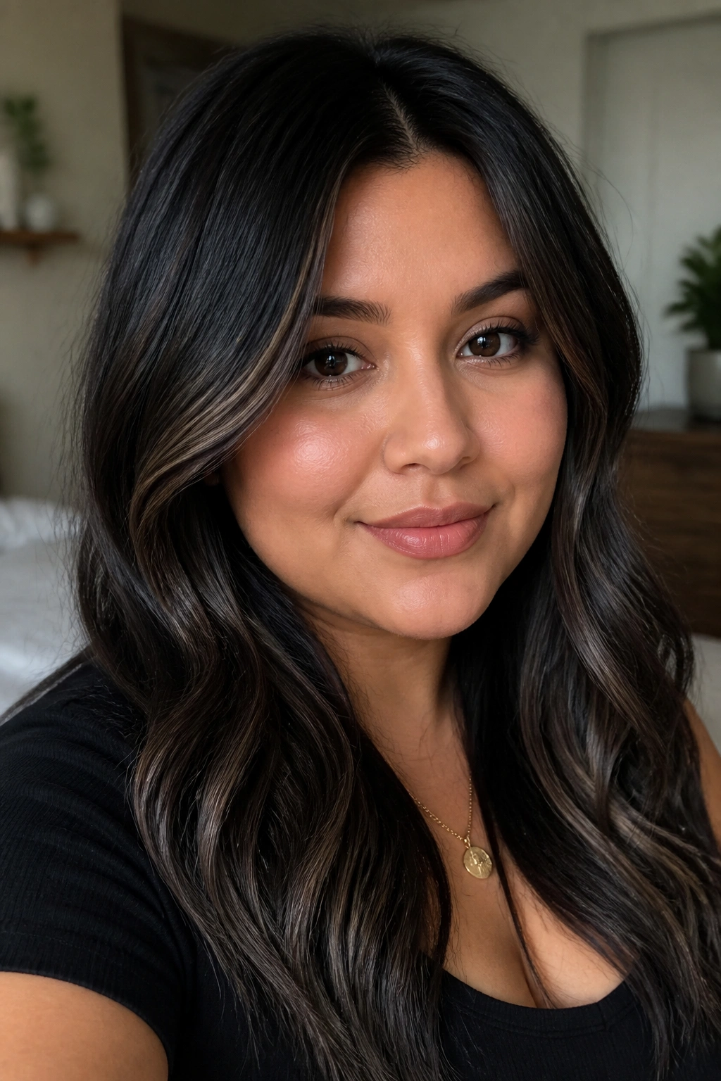 Close-up of a real woman with smoky black hair and ash-brown lowlights
