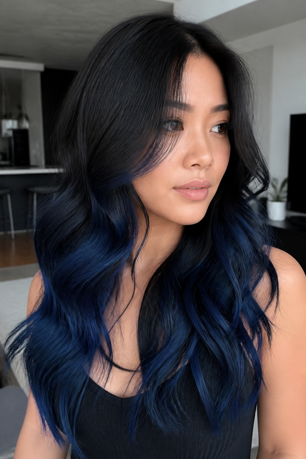 Close-up of real woman with smoky blue ombre on dark hair with waves