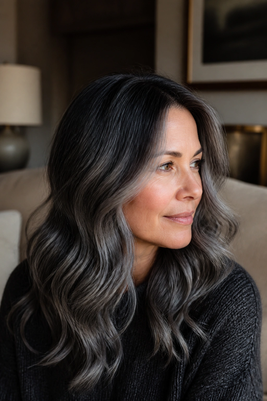 Close-up portrait of a real woman with smoky charcoal root melt hairstyle.