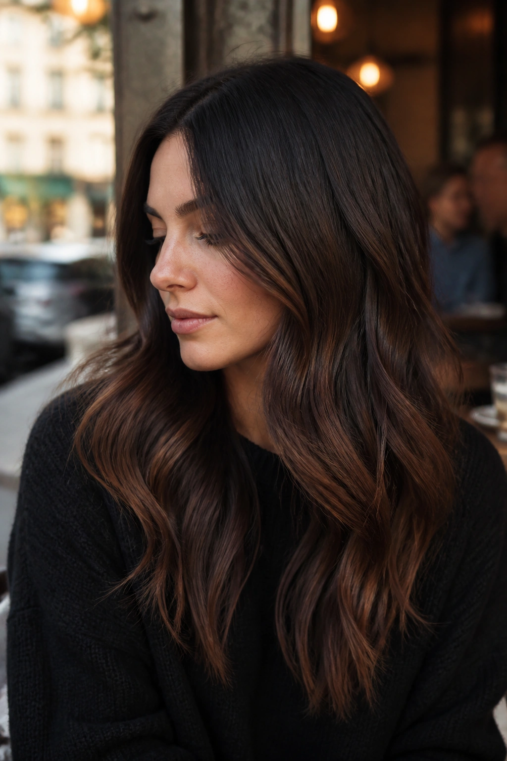 Close-up of a real person with smoky chestnut ombré showing a soft transition from roots to ends