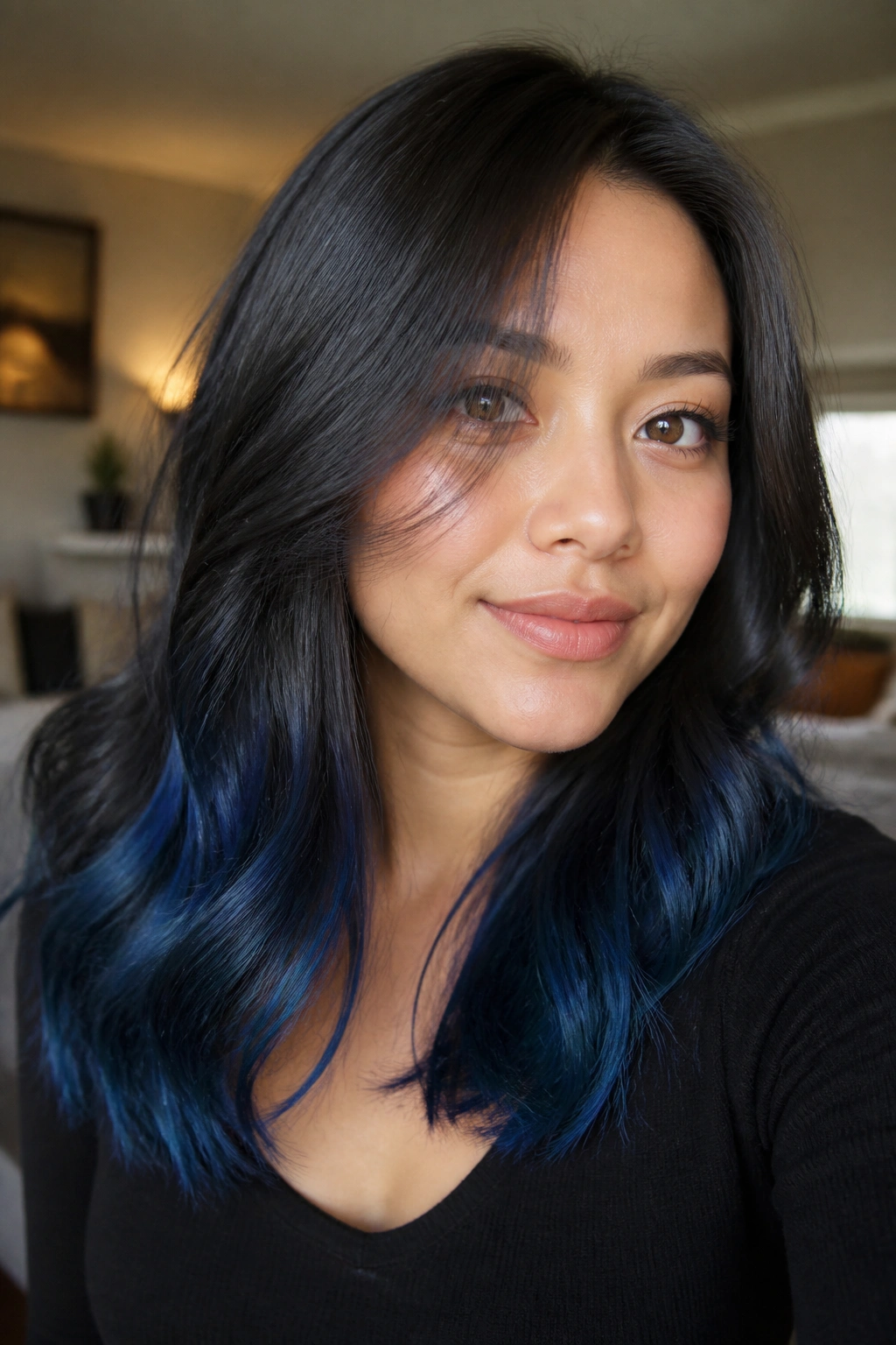 Portrait of a woman with smoky cobalt blue tips at the ends.