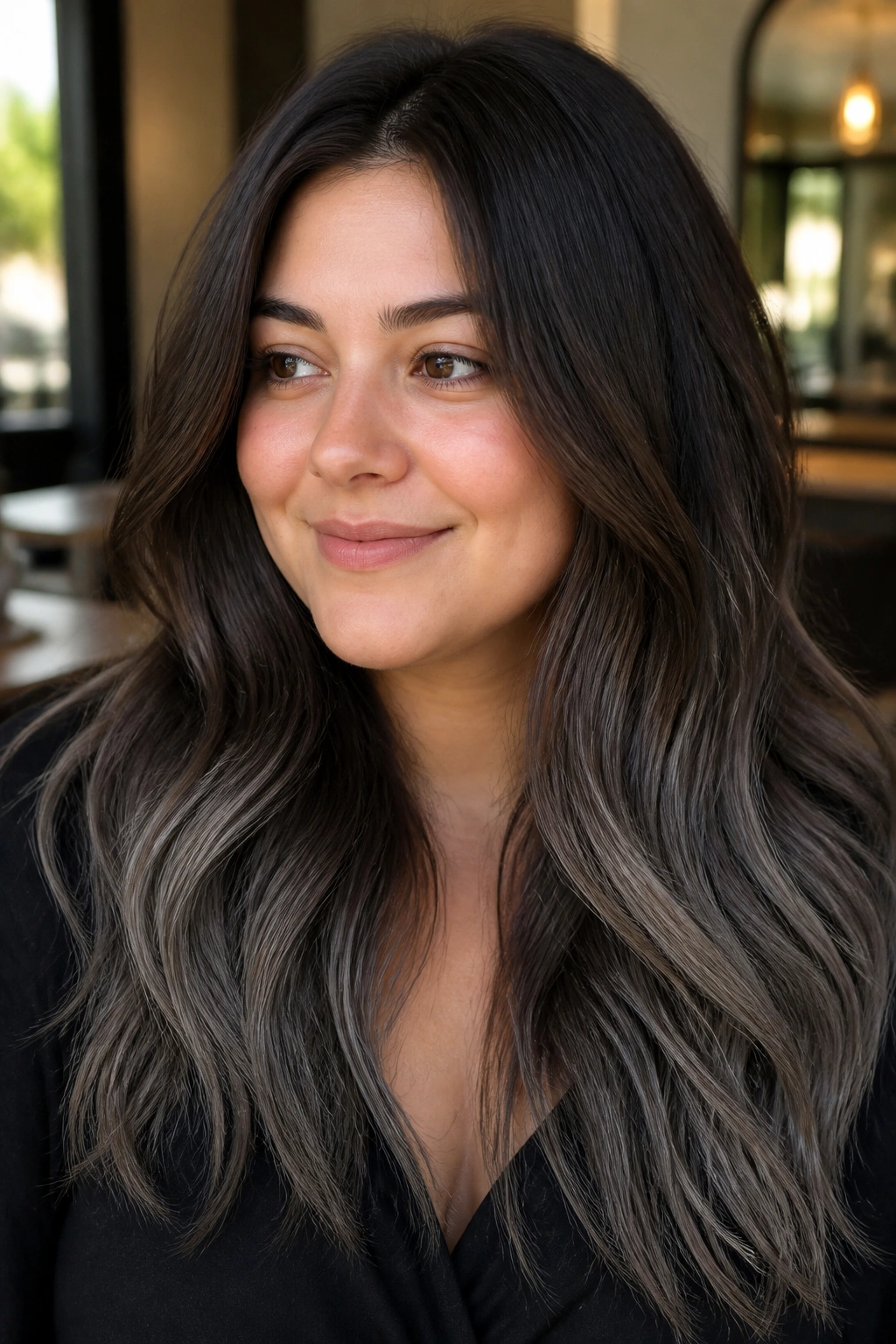 Close-up of a real woman with smoky grey ends on chestnut hair, long locks filling the frame
