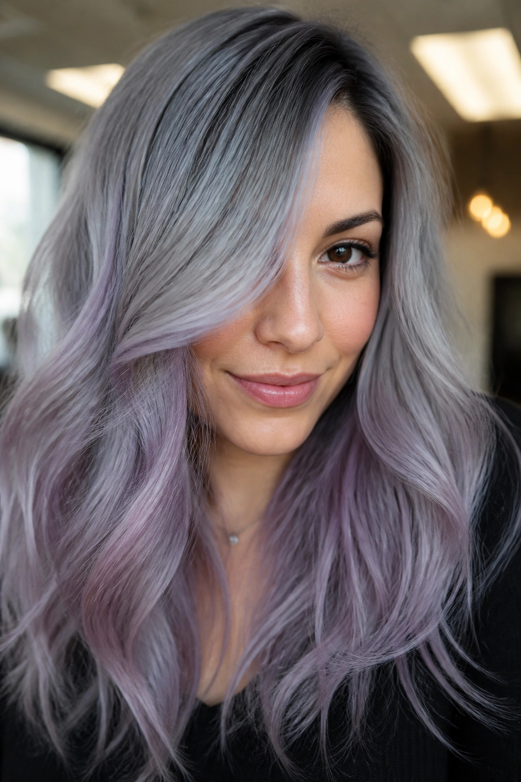 Close-up of a woman with smoky gray hair and lavender wash.