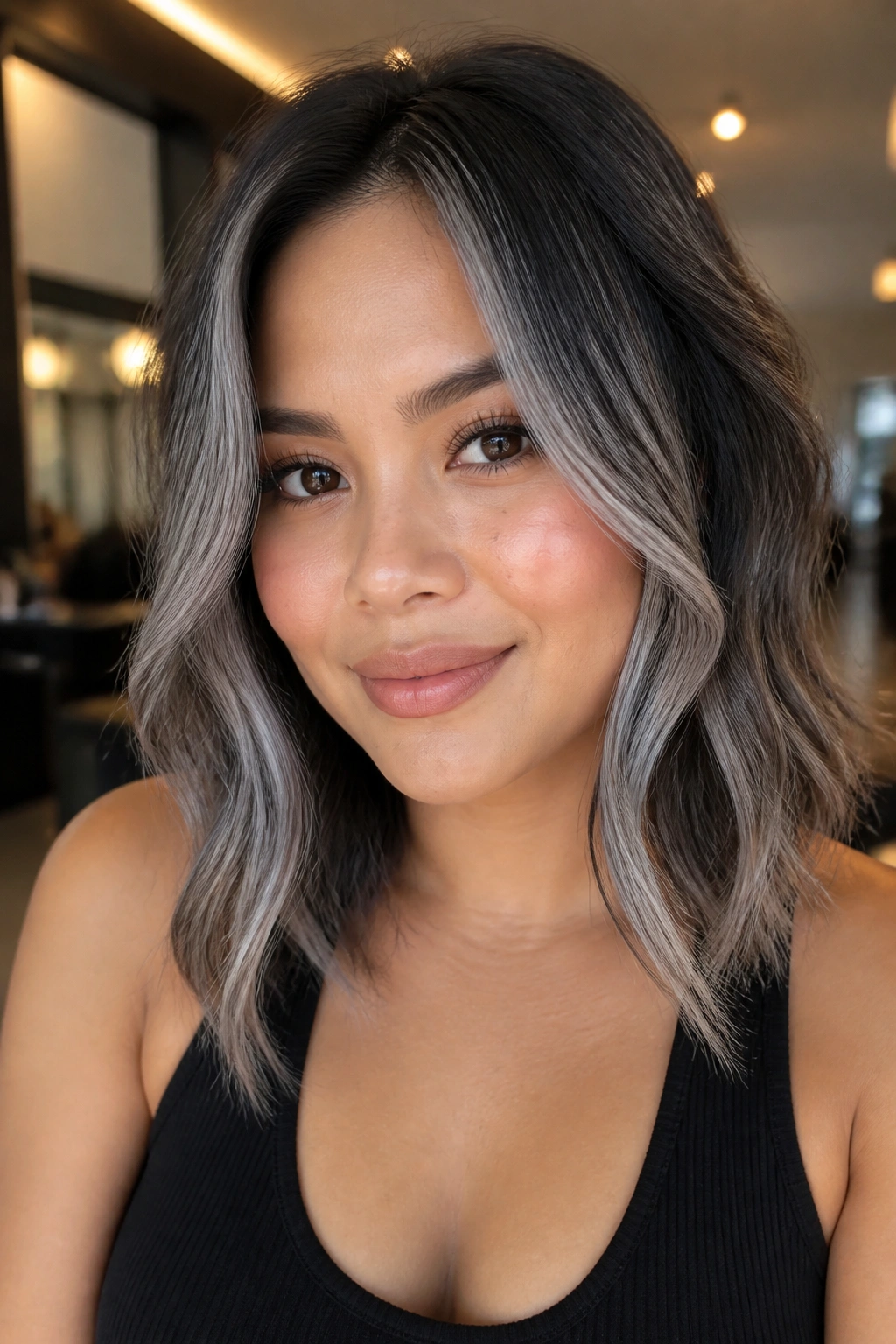 Close-up of a real woman showcasing smoky money piece with shadow roots around the face