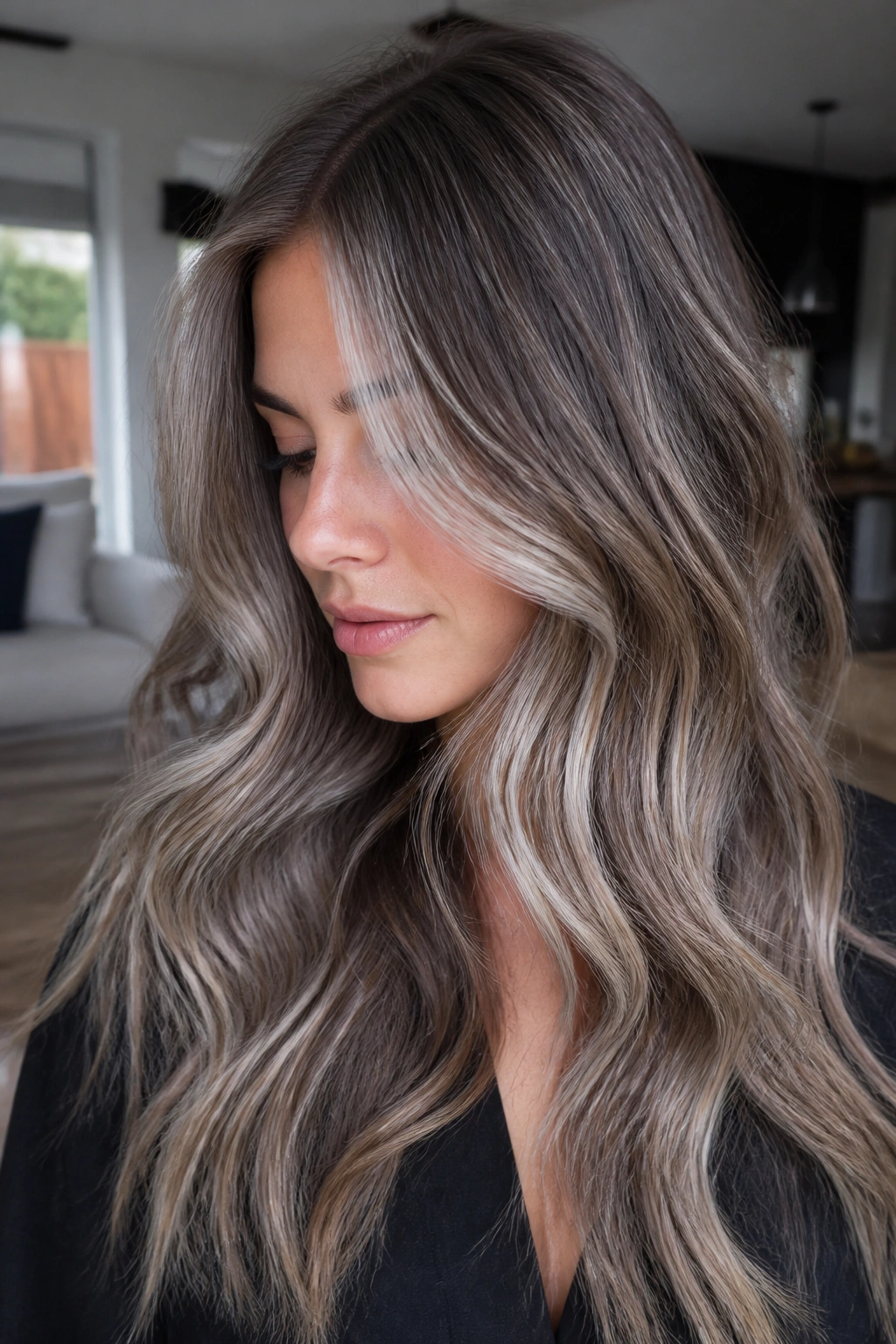 Close-up of a real person with smoky mushroom brown hair and white balayage
