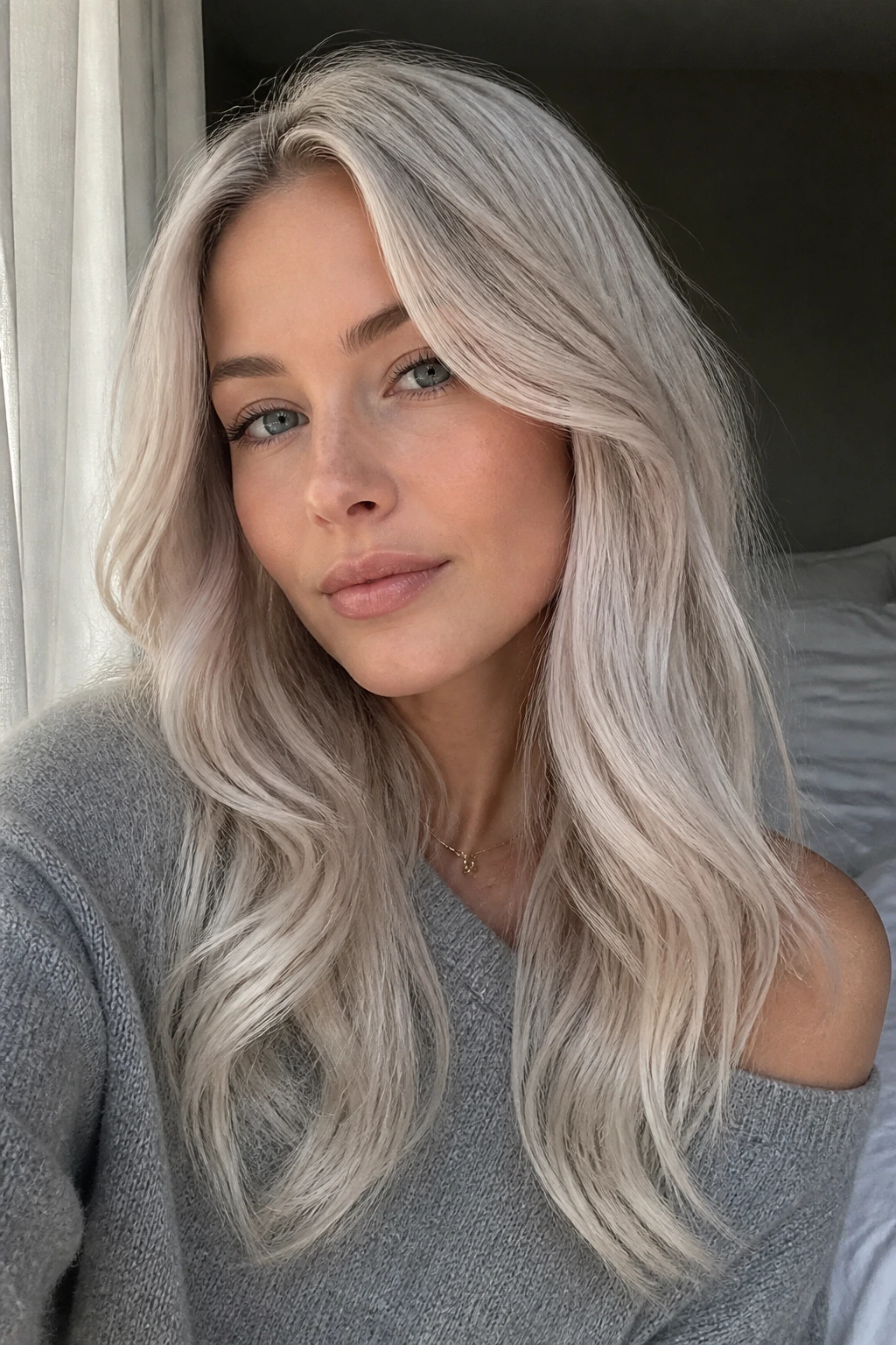 Close-up of a woman with smoky pearl blonde hair and soft depth
