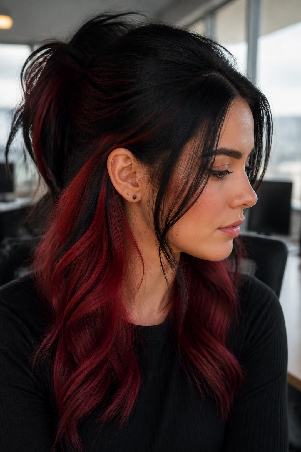 Close-up of a real woman showing smoky red underlayers peeking from black hair in a half-up style