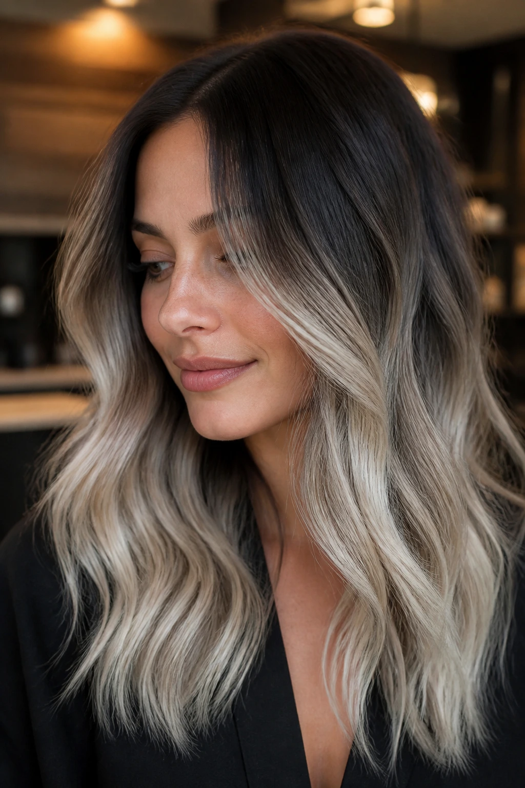 Close-up of a woman with smoky root melt and platinum ends in brown hair.