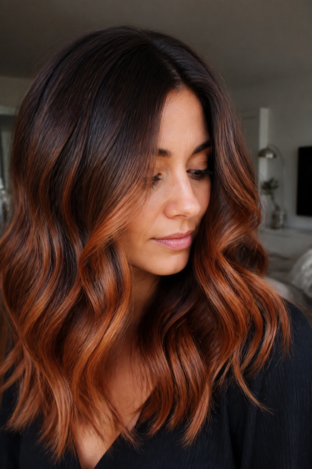 Close-up of hair with smoky root shadow transitioning to copper balayage