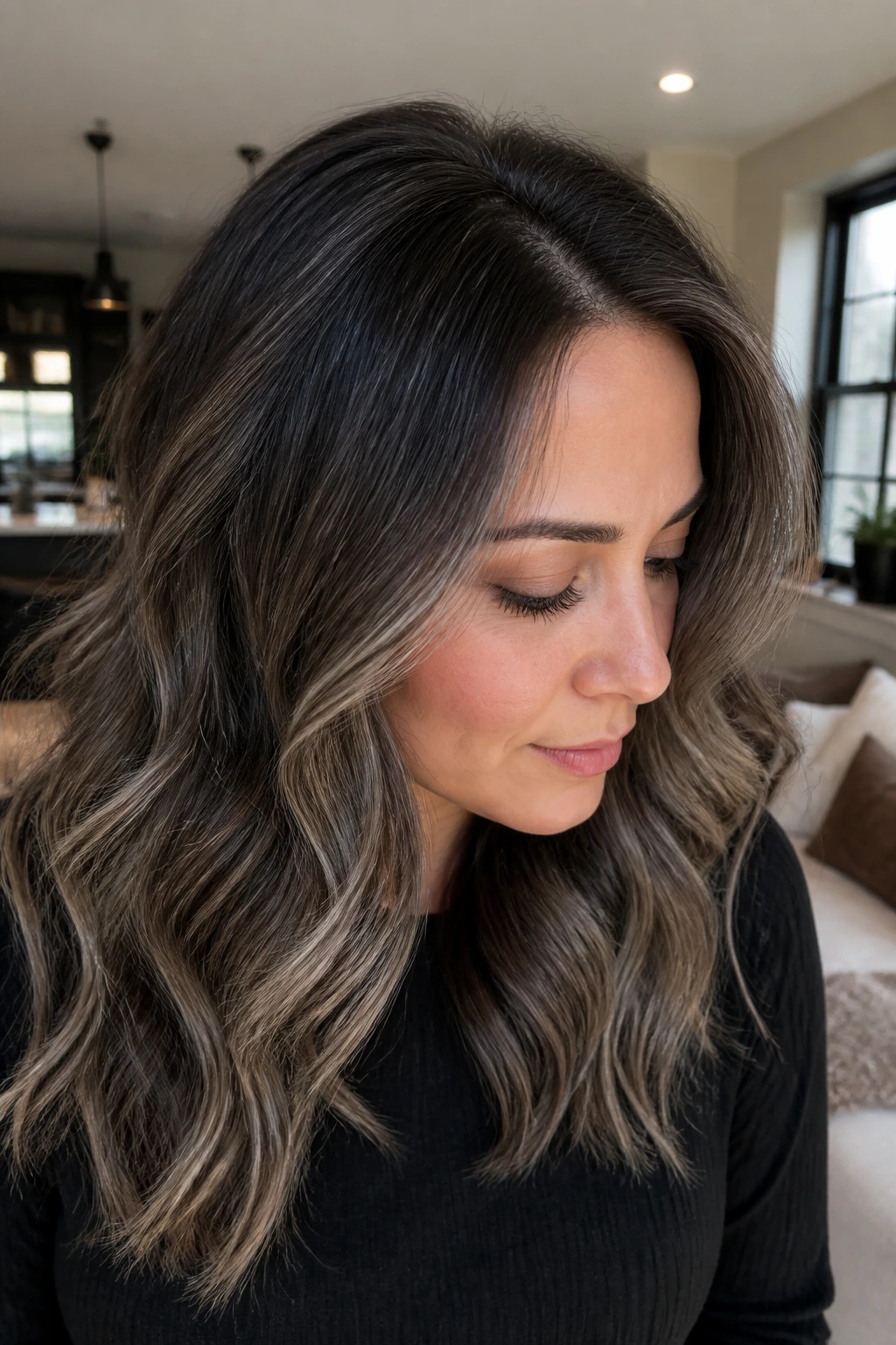 Close-up portrait of a real woman with smoky root smudge and gray lights in the hair