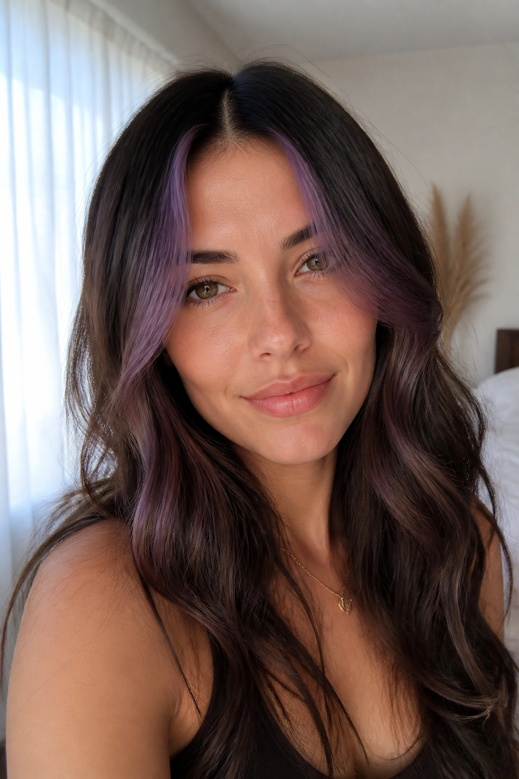 Real woman's face with soft grape face-frame balayage around cheeks