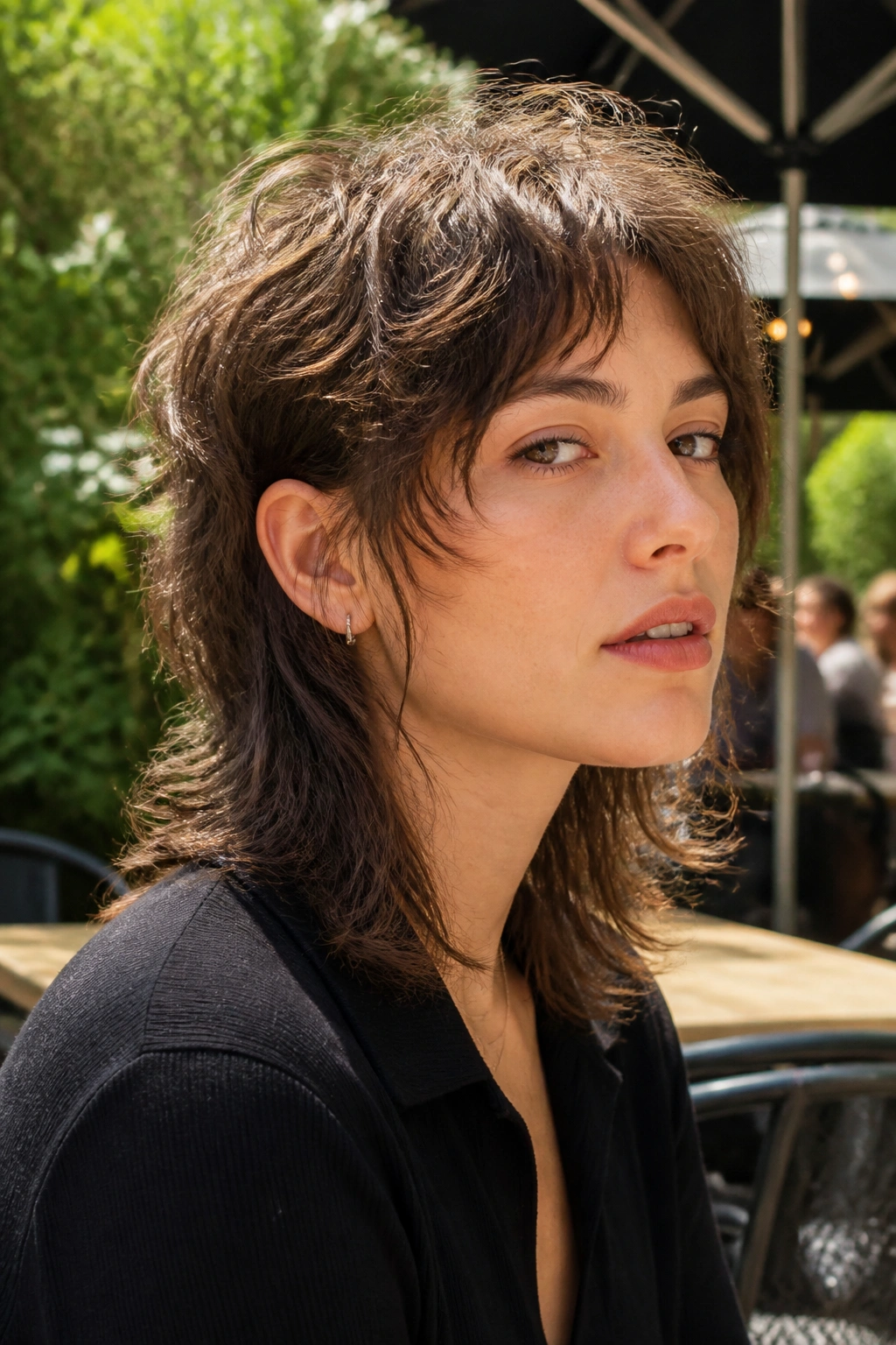 Close-up portrait of a real person with a soft mullet and face-framing pieces.