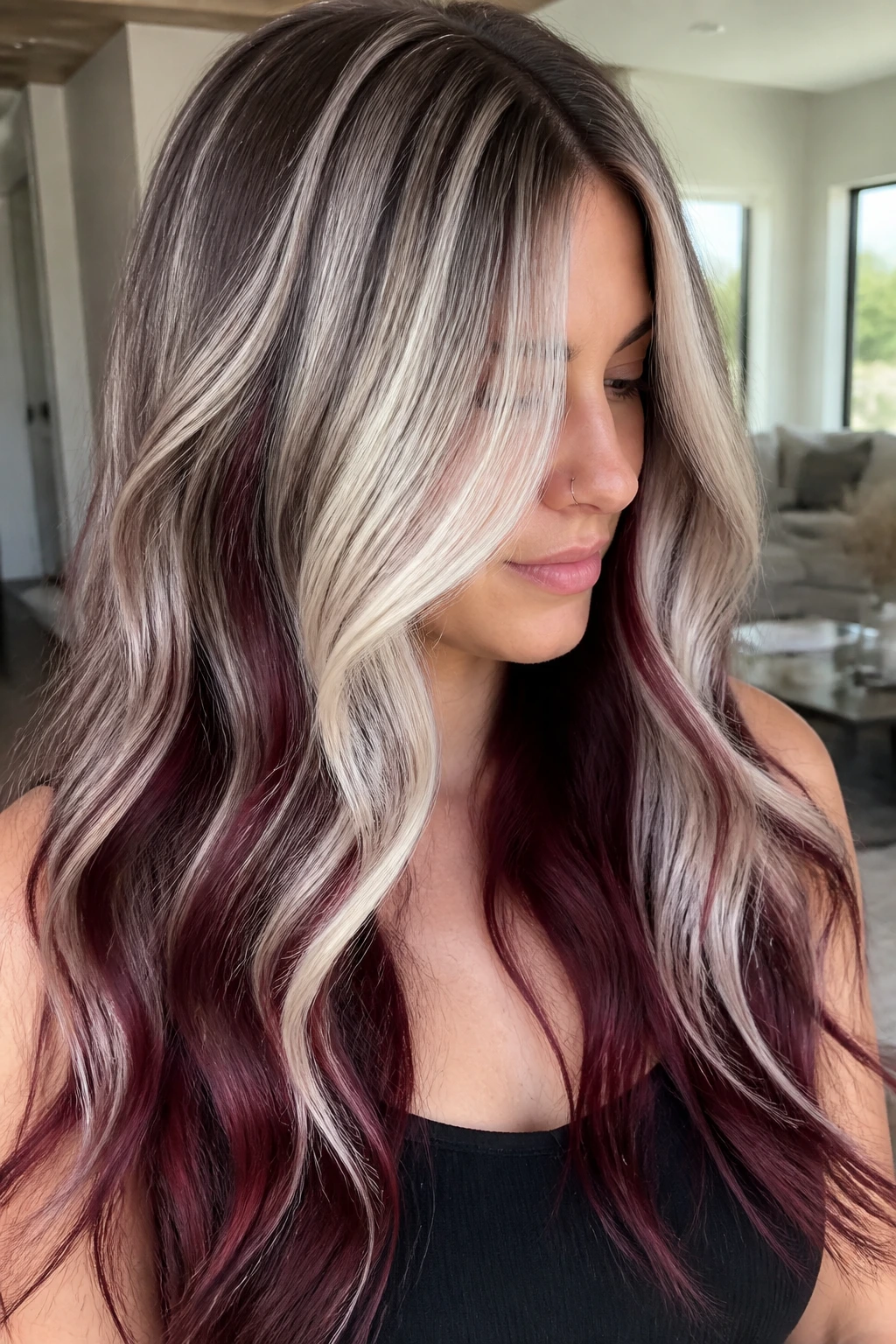 Close-up of a real woman with soft smoke blonde melt and burgundy-platinum
